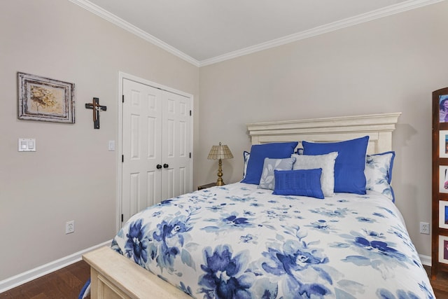  - bedroom with ornamental molding, wood finished floors, baseboards, and a closet