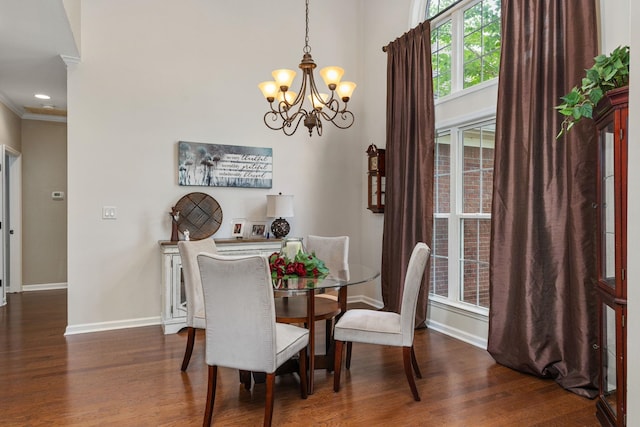  - dining room featuring wood finished floors, a chandelier, baseboards, crown molding, and recessed lighting