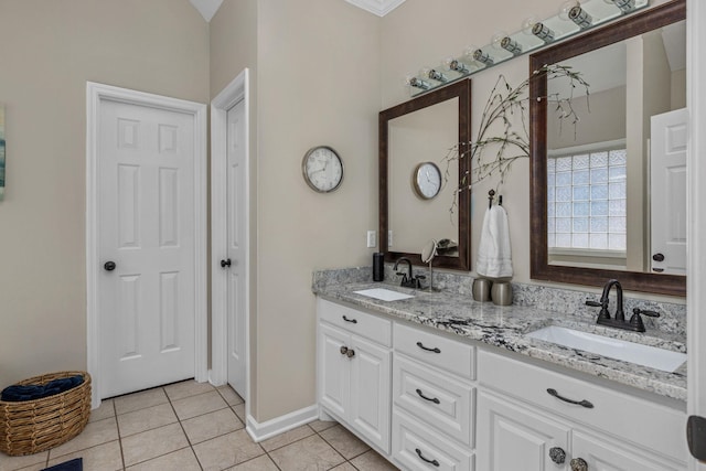  - full bath with tile patterned floors, double vanity, and baseboards