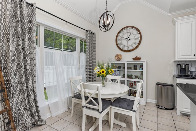  - dining area featuring light tile patterned floors, crown molding, a chandelier, vaulted ceiling, and baseboards