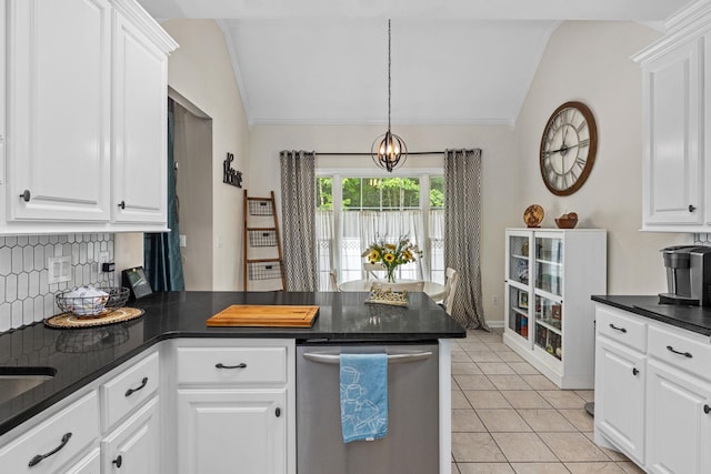  - kitchen with vaulted ceiling, dark countertops, backsplash, a peninsula, and stainless steel dishwasher