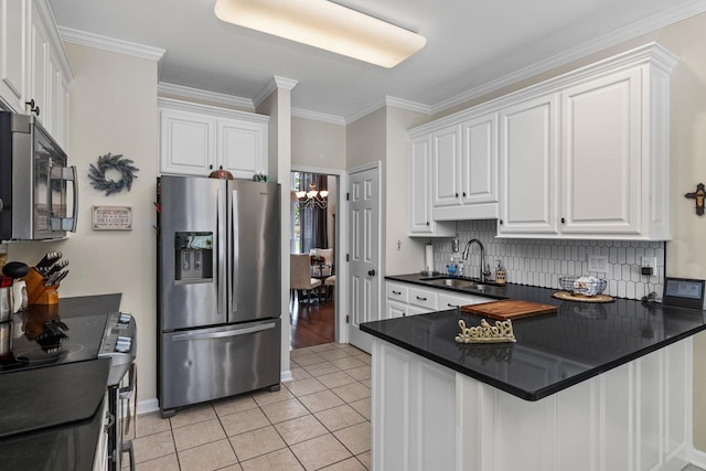  - kitchen featuring stainless steel fridge with ice dispenser, a sink, dark countertops, white cabinetry, and ornamental molding