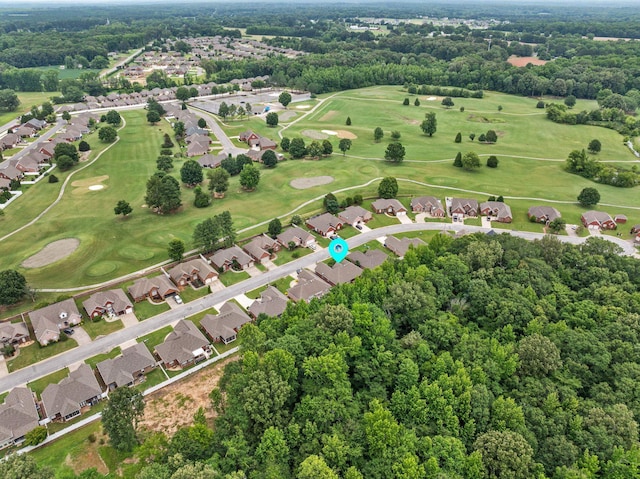  - aerial view of property's location featuring nearby suburban area, a local golf course, and a tree filled landscape