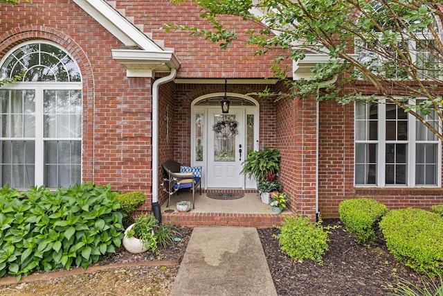 - doorway to property featuring brick siding