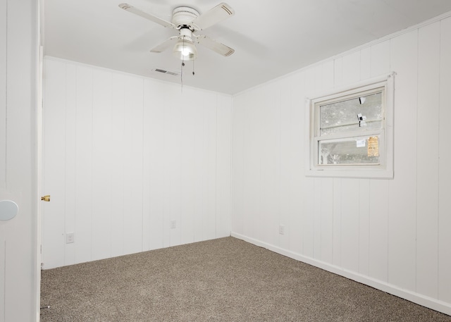 - spare room with carpet, a ceiling fan, and visible vents