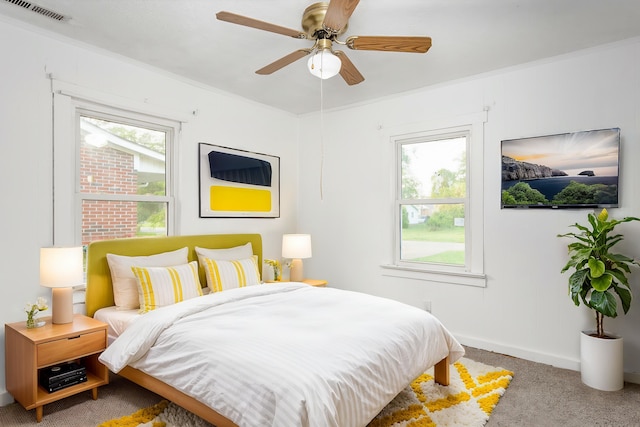  - carpeted bedroom featuring baseboards, visible vents, multiple windows, and ornamental molding