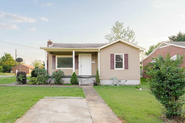 - view of front of house with a chimney and a front lawn