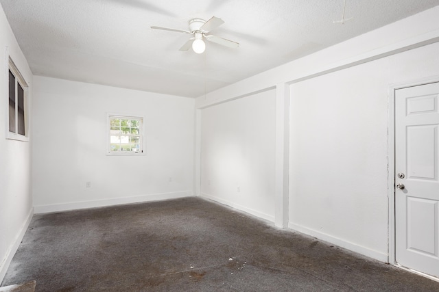  - carpeted spare room with a ceiling fan and baseboards