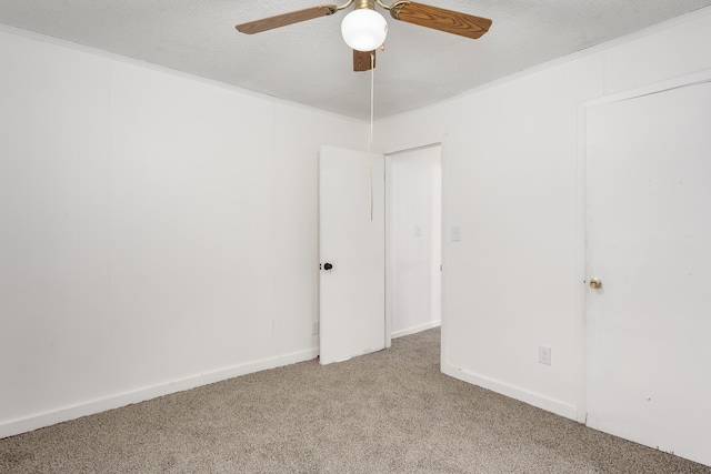  - spare room featuring light colored carpet, a ceiling fan, and a textured ceiling