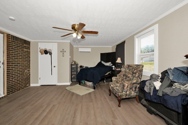 bedroom featuring ceiling fan, hardwood / wood-style floors, brick wall, and a textured ceiling