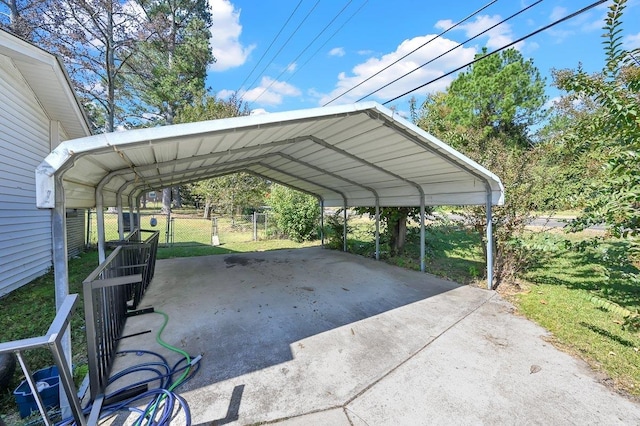 view of parking / parking lot with a lawn and a carport