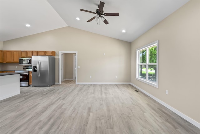 kitchen with appliances with stainless steel finishes, light hardwood / wood-style floors, ceiling fan, and lofted ceiling