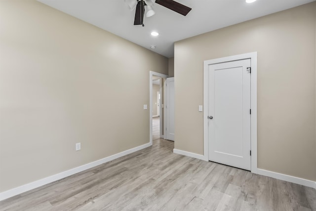 spare room with light hardwood / wood-style floors and ceiling fan