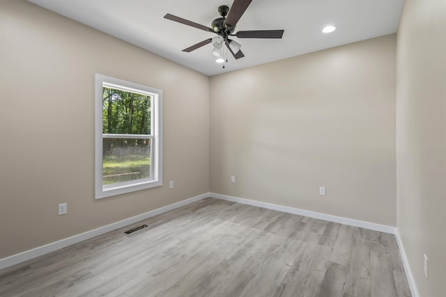 spare room featuring light wood-type flooring and ceiling fan