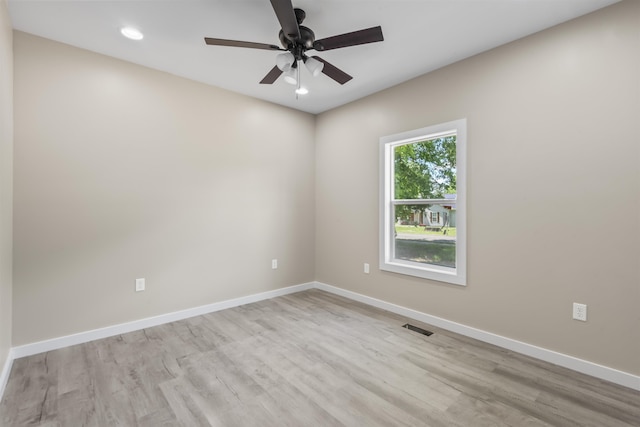 spare room featuring ceiling fan and light hardwood / wood-style floors