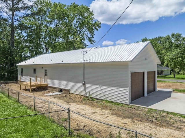 view of side of property featuring a garage and an outdoor structure