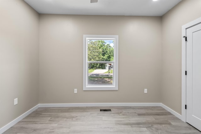 spare room featuring light wood-type flooring