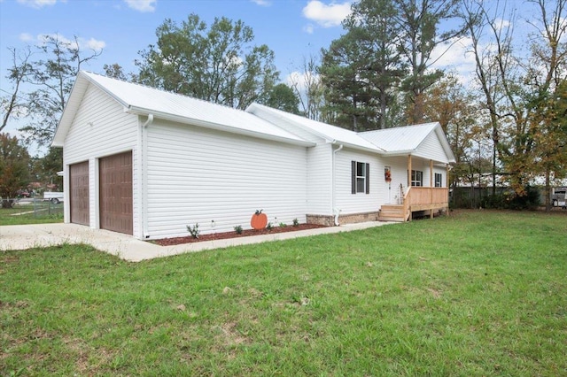 exterior space featuring a lawn and a garage