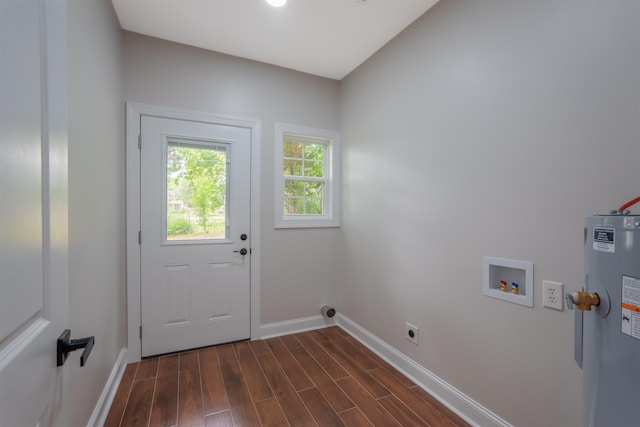 clothes washing area with electric dryer hookup, baseboards, water heater, washer hookup, and dark wood finished floors