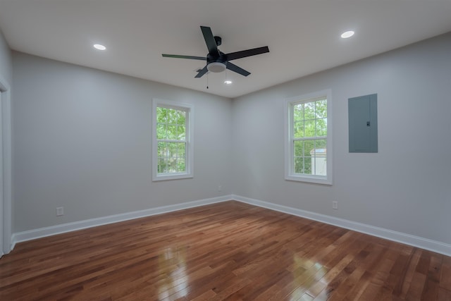 spare room featuring electric panel, dark wood-style flooring, healthy amount of natural light, ceiling fan, and recessed lighting