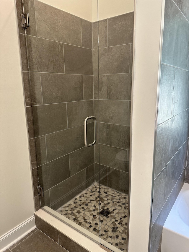 bathroom featuring shower with separate bathtub