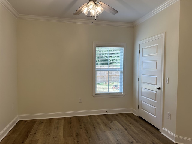 spare room with ceiling fan, crown molding, and dark wood-type flooring