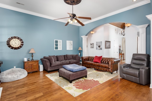 living room with ornate columns, ceiling fan, hardwood / wood-style floors, and ornamental molding