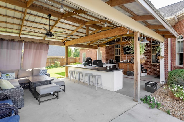 view of patio / terrace with ceiling fan, an outdoor living space, exterior bar, a gazebo, and area for grilling