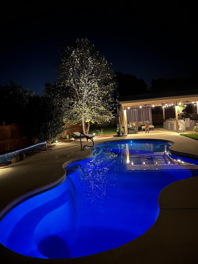 pool at night with a patio