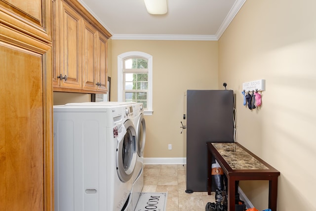 washroom featuring washer and dryer, cabinets, and ornamental molding