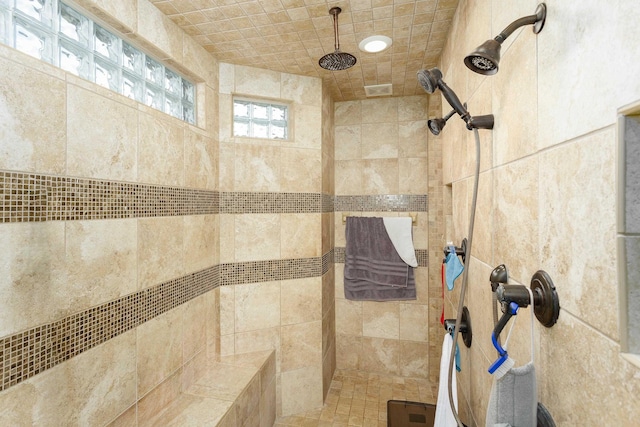 bathroom with tiled shower