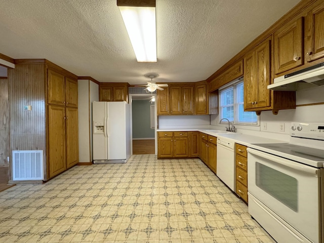 kitchen featuring a textured ceiling, white appliances, ceiling fan, and sink