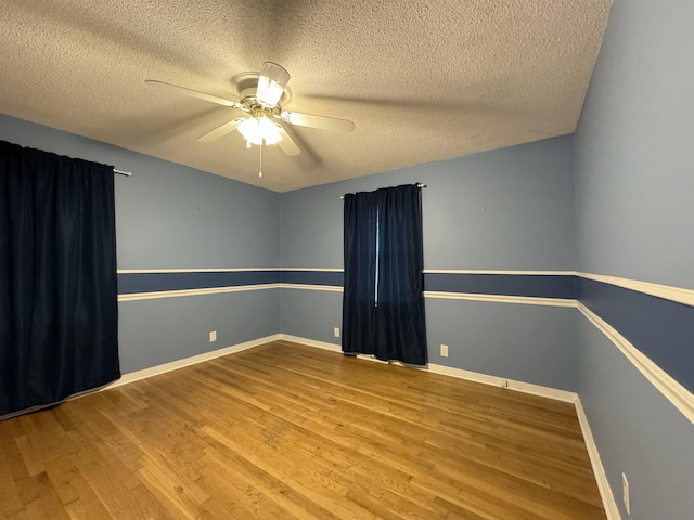 unfurnished room with a textured ceiling, hardwood / wood-style flooring, and ceiling fan