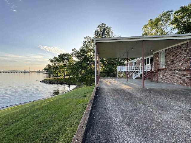 exterior space with a lawn and a water view