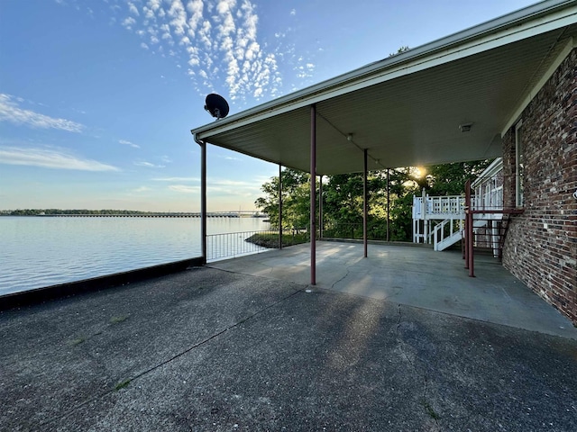 view of patio with a water view