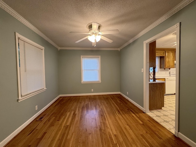 unfurnished room with ceiling fan, light hardwood / wood-style floors, ornamental molding, and a textured ceiling