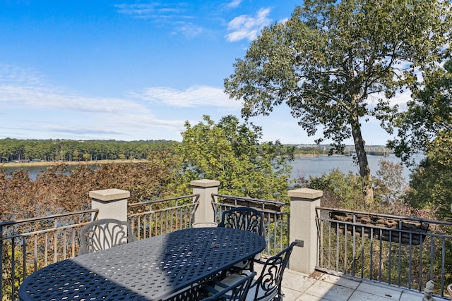 - balcony with outdoor dining area and a water view