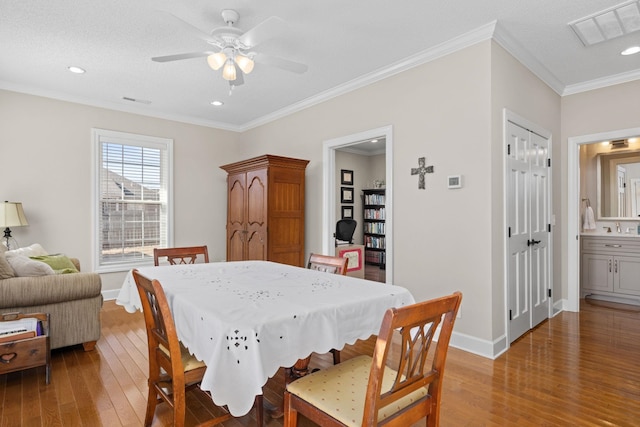 dining space with crown molding, ceiling fan, sink, and hardwood / wood-style floors