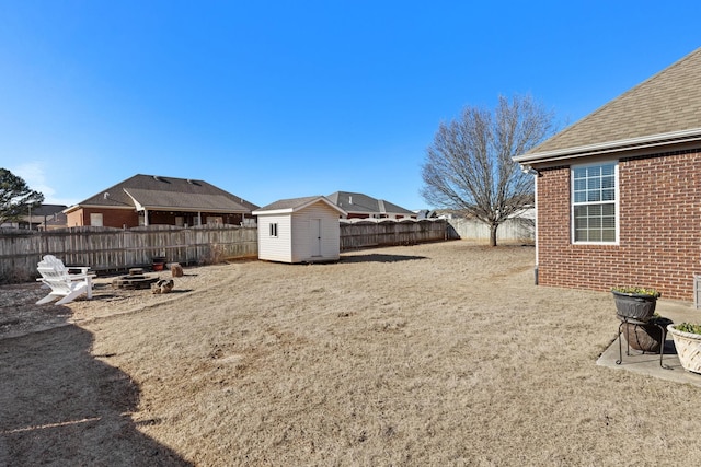 view of yard with a storage shed and a fire pit