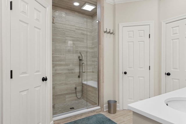 bathroom featuring hardwood / wood-style flooring, sink, and an enclosed shower