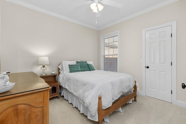 carpeted bedroom featuring ceiling fan and ornamental molding