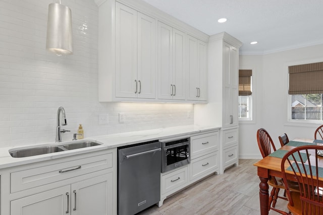 kitchen featuring sink, dishwasher, backsplash, light stone counters, and white cabinets