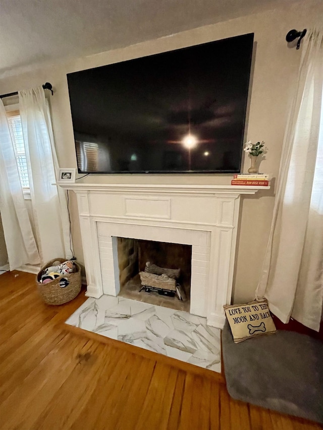 detailed view of a fireplace and wood finished floors