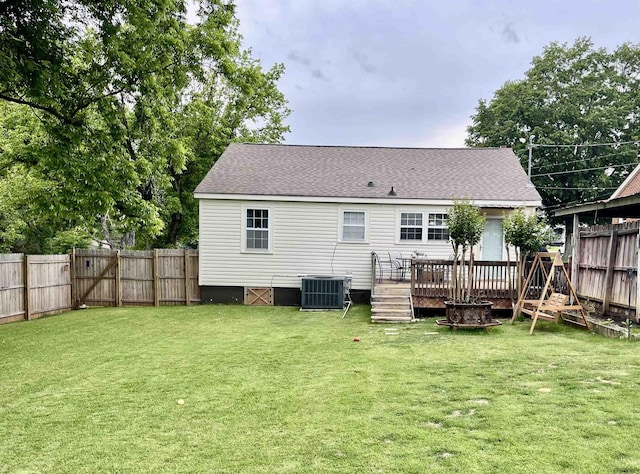 back of house with central air condition unit, a deck, and a shingled roof