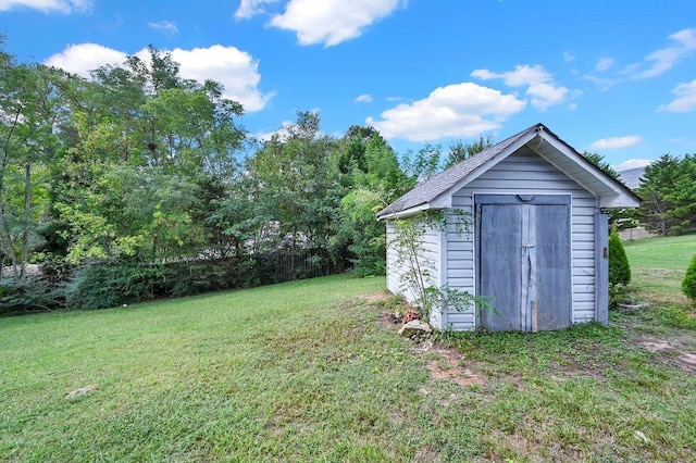 view of yard featuring an outbuilding and a shed