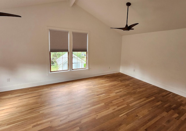 unfurnished room with ceiling fan, baseboards, wood finished floors, and vaulted ceiling with beams