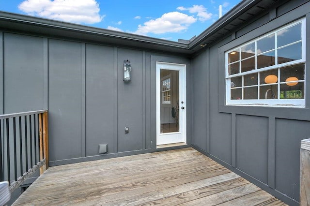 property entrance with a deck and board and batten siding