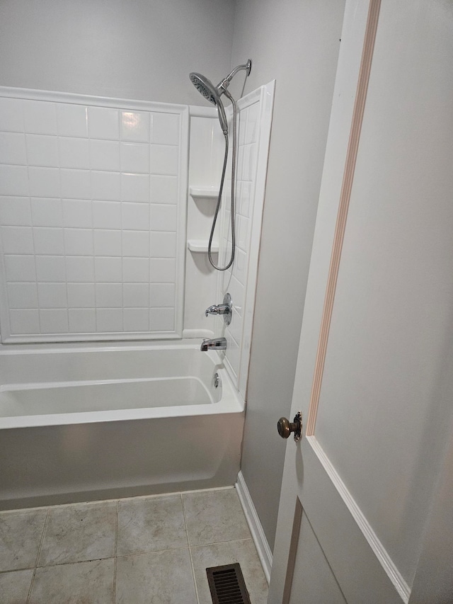 bathroom with tile patterned flooring and washtub / shower combination