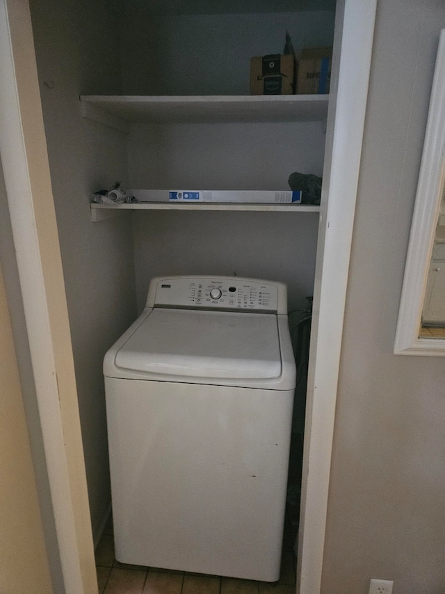 washroom with light tile patterned flooring and washer / dryer