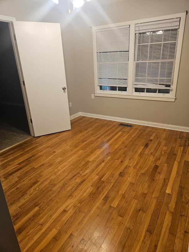 empty room featuring hardwood / wood-style flooring